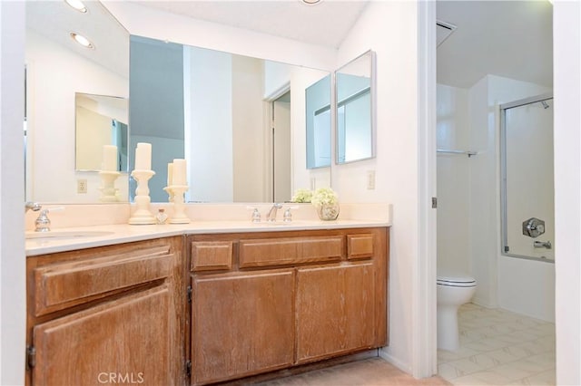 bathroom with double vanity, toilet, bathing tub / shower combination, and a sink