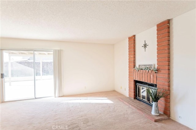 unfurnished living room with carpet flooring, a fireplace, and a textured ceiling