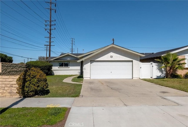 ranch-style house featuring stucco siding, driveway, a gate, an attached garage, and a front yard