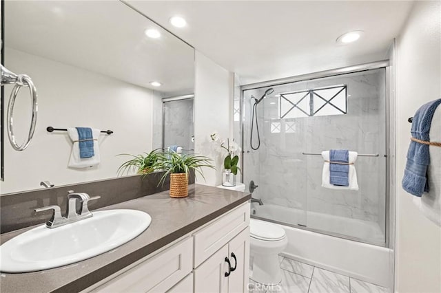 bathroom with toilet, marble finish floor, combined bath / shower with glass door, recessed lighting, and vanity