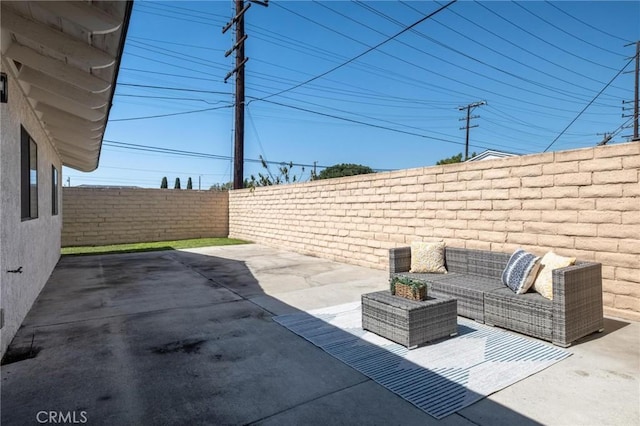 view of patio featuring an outdoor hangout area and a fenced backyard