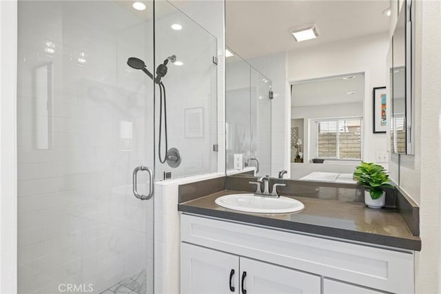 full bath with a shower stall and vanity