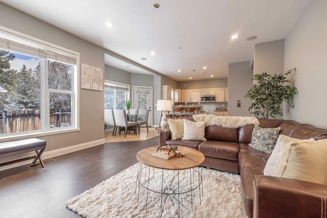 living room featuring visible vents, recessed lighting, dark wood-style floors, and baseboards