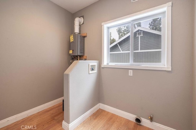 washroom featuring laundry area, wood finished floors, baseboards, and washer hookup