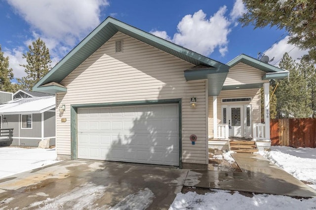 view of front of property featuring a porch, an attached garage, and driveway