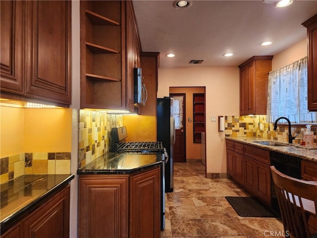 kitchen featuring visible vents, a sink, open shelves, dark stone countertops, and stainless steel appliances