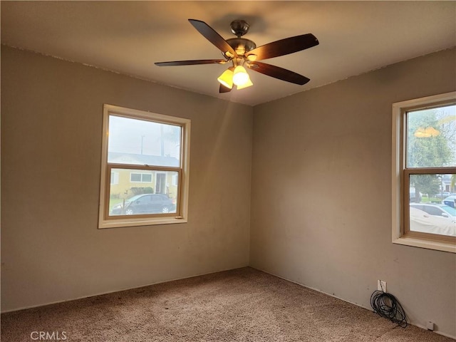 unfurnished room featuring light colored carpet and ceiling fan