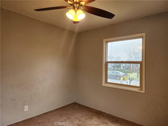 spare room with carpet and ceiling fan