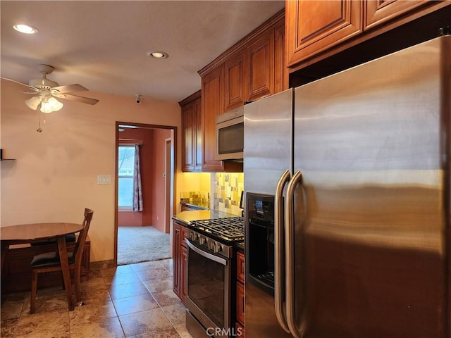 kitchen featuring tasteful backsplash, brown cabinets, stainless steel appliances, and ceiling fan