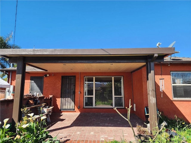 back of property featuring stucco siding and a patio