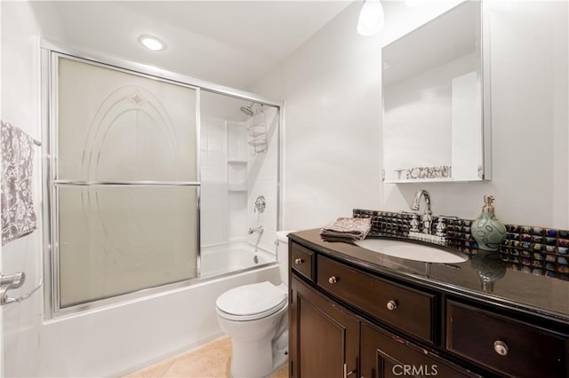 full bathroom featuring vanity, toilet, tile patterned flooring, and enclosed tub / shower combo