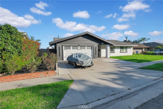 single story home with a garage, concrete driveway, and a front yard