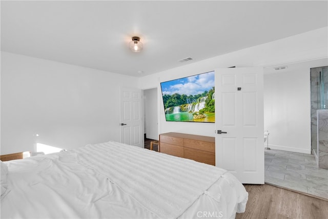 bedroom with wood finished floors and visible vents