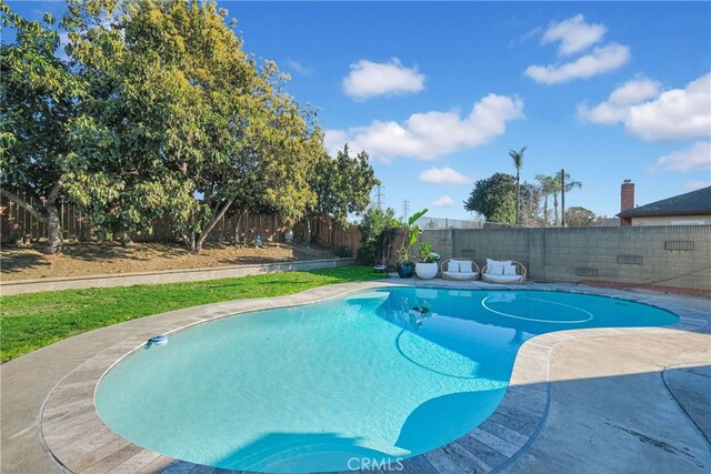 view of pool with a fenced backyard