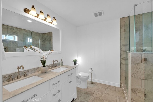 full bath featuring visible vents, a shower stall, and a sink