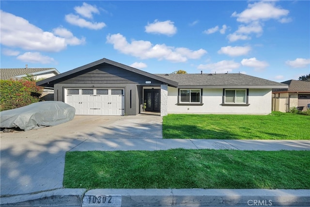 ranch-style house featuring a garage, driveway, a front yard, and stucco siding