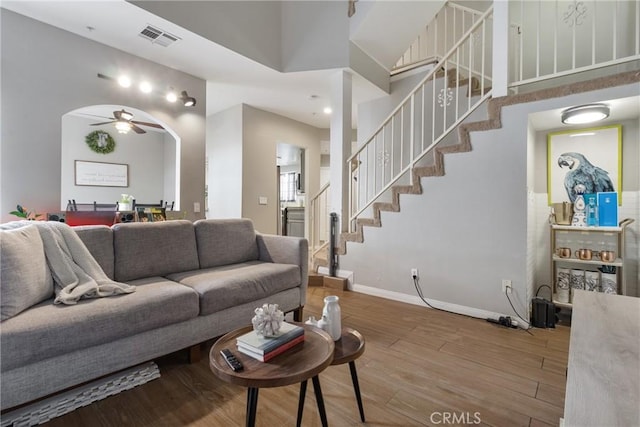 14039 Astoria St Unit 120, Sylmar, CA 91342 - living area featuring a ceiling fan, stairway, wood finished floors, and a high ceiling