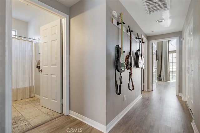 14039 Astoria St Unit 120, Sylmar, CA 91342 - hallway featuring wood finished floors, plenty of natural light, and a barn door