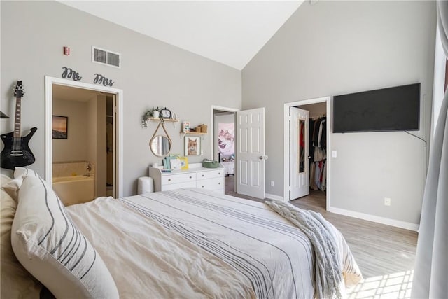 14039 Astoria St Unit 120, Sylmar, CA 91342 - bedroom with high vaulted ceiling, wood finished floors, a walk in closet, connected bathroom, and a closet