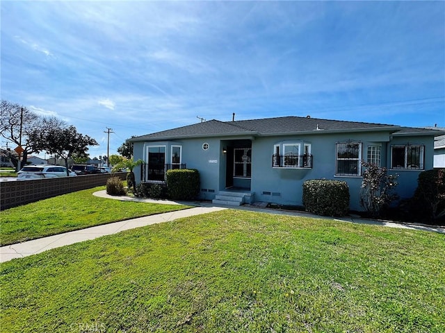 view of front of home with stucco siding and a front yard