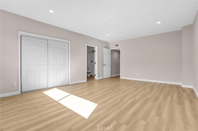 unfurnished bedroom featuring recessed lighting, a closet, baseboards, and light wood-style floors