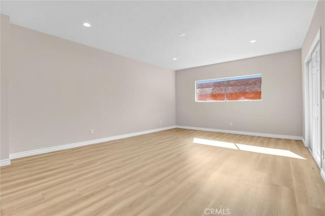 unfurnished bedroom with light wood finished floors, recessed lighting, and baseboards