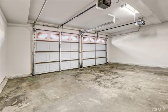 garage featuring a garage door opener and baseboards