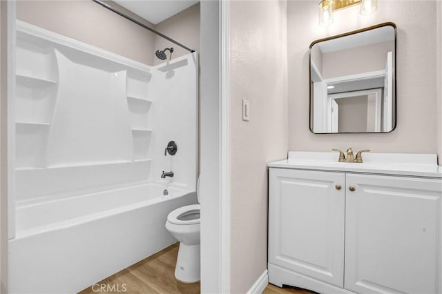 full bath with shower / bath combination, toilet, vanity, and wood finished floors