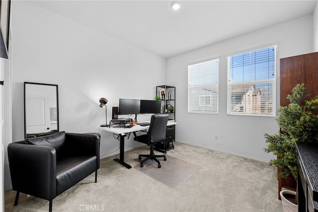 carpeted home office with baseboards