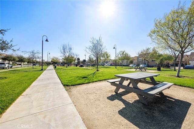 view of property's community with a yard