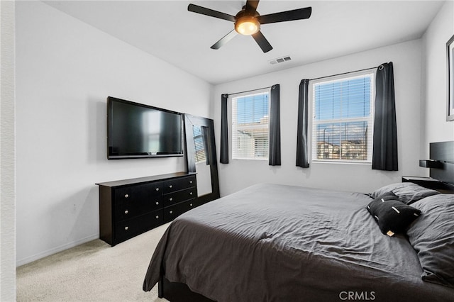 bedroom featuring visible vents, baseboards, ceiling fan, and carpet flooring