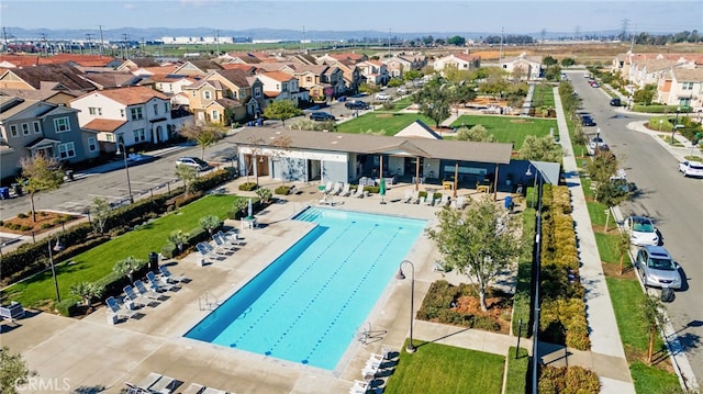 pool with a residential view and a patio