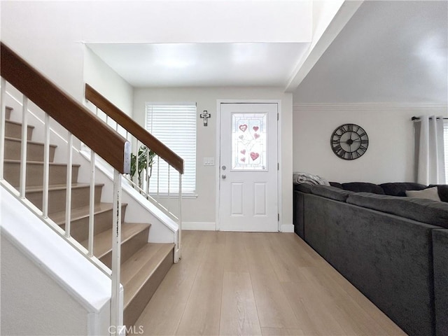 entrance foyer with light wood finished floors and stairway