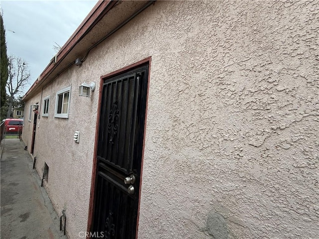 view of side of home featuring stucco siding