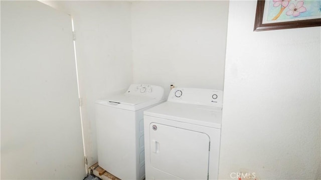 clothes washing area featuring laundry area and washing machine and clothes dryer