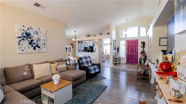 living room featuring a chandelier, visible vents, high vaulted ceiling, and wood finished floors