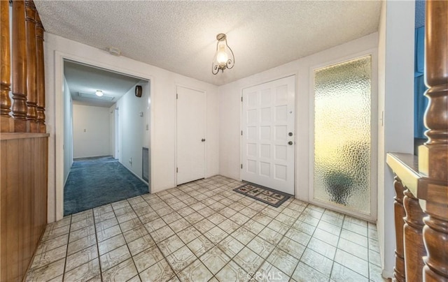 foyer featuring plenty of natural light and a textured ceiling