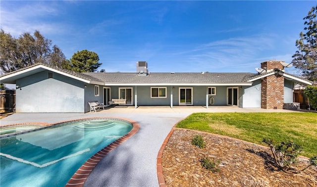 23187 Glendora Dr, Grand Terrace, CA 92313 - back of property featuring a chimney, a patio, stucco siding, and a pool with connected hot tub