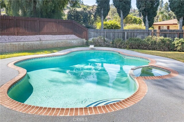 23187 Glendora Dr, Grand Terrace, CA 92313 - view of pool with a fenced backyard and a pool with connected hot tub
