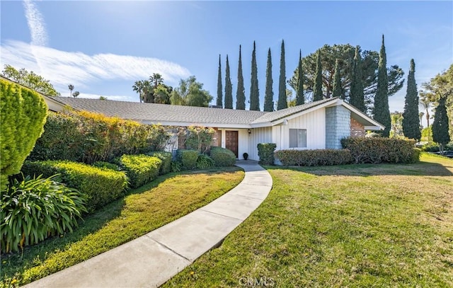 23187 Glendora Dr, Grand Terrace, CA 92313 - view of front of house with a front yard and board and batten siding