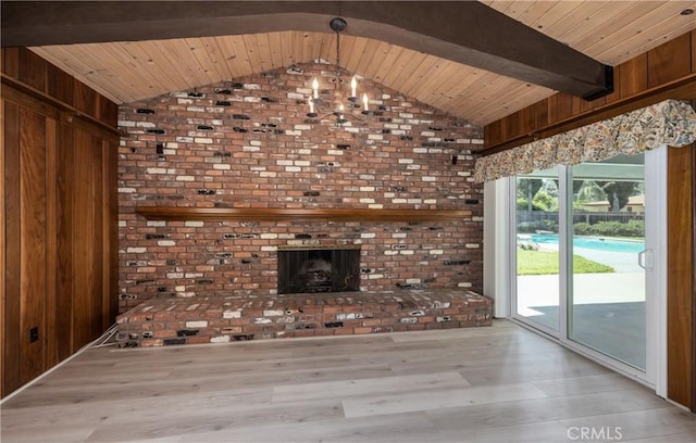 23187 Glendora Dr, Grand Terrace, CA 92313 - unfurnished living room with wood finished floors, wooden walls, a fireplace, wood ceiling, and a chandelier