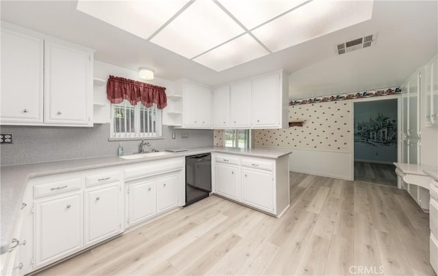 23187 Glendora Dr, Grand Terrace, CA 92313 - kitchen with black dishwasher, open shelves, a sink, white cabinetry, and wallpapered walls