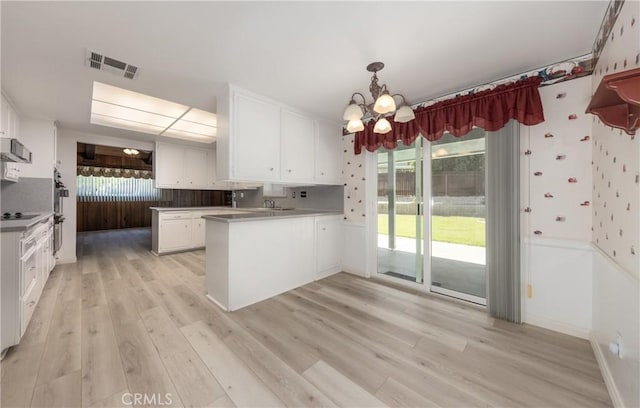 23187 Glendora Dr, Grand Terrace, CA 92313 - kitchen with a peninsula, light wood-style floors, white cabinetry, a chandelier, and light countertops