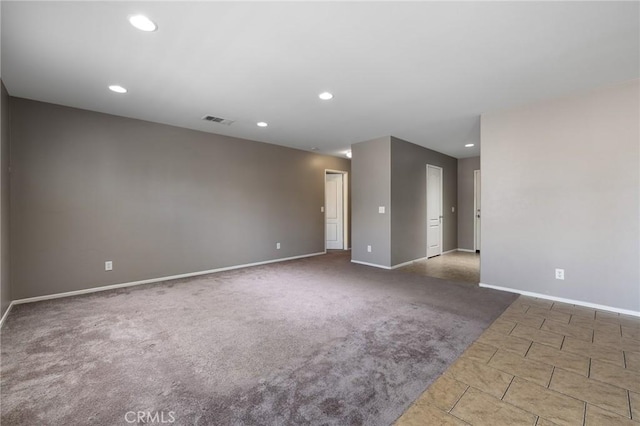 unfurnished room featuring carpet flooring, recessed lighting, visible vents, and baseboards