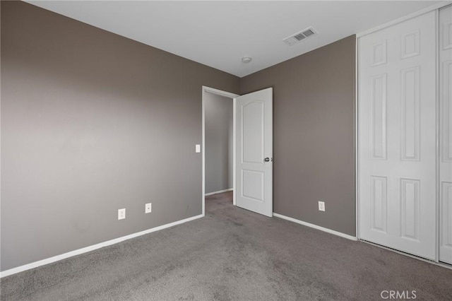 unfurnished bedroom featuring carpet flooring, baseboards, and visible vents