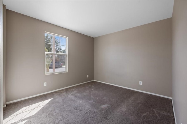 carpeted empty room with baseboards