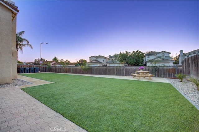 view of yard featuring a patio area and a fenced backyard