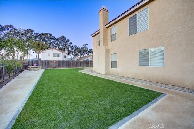 view of yard featuring a patio and a fenced backyard