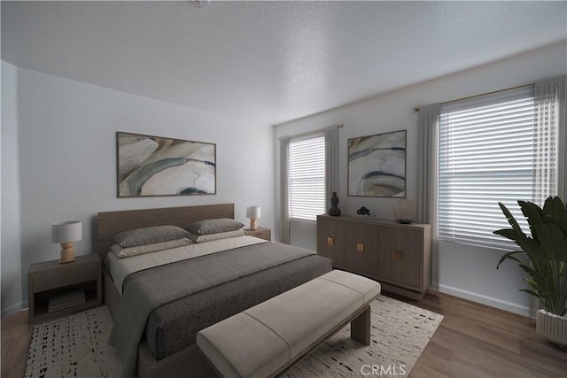 bedroom with wood finished floors and baseboards