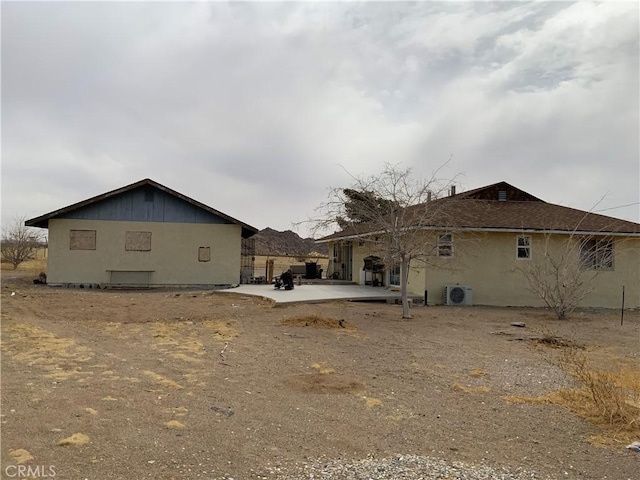 exterior space with a patio area and ac unit